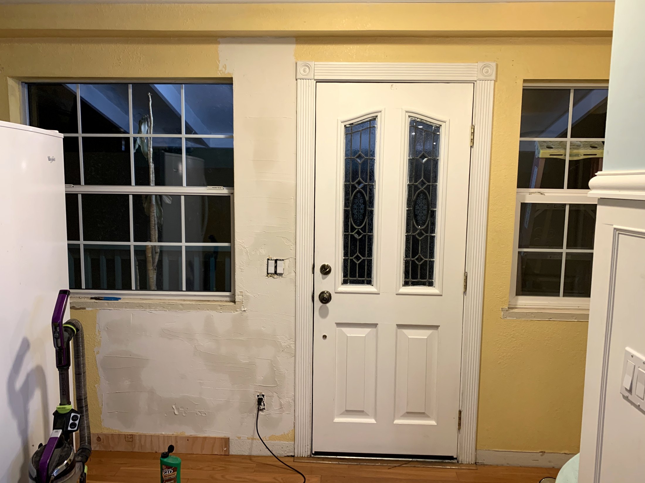 Yellow farmhouse entry wall before the final paneling was built