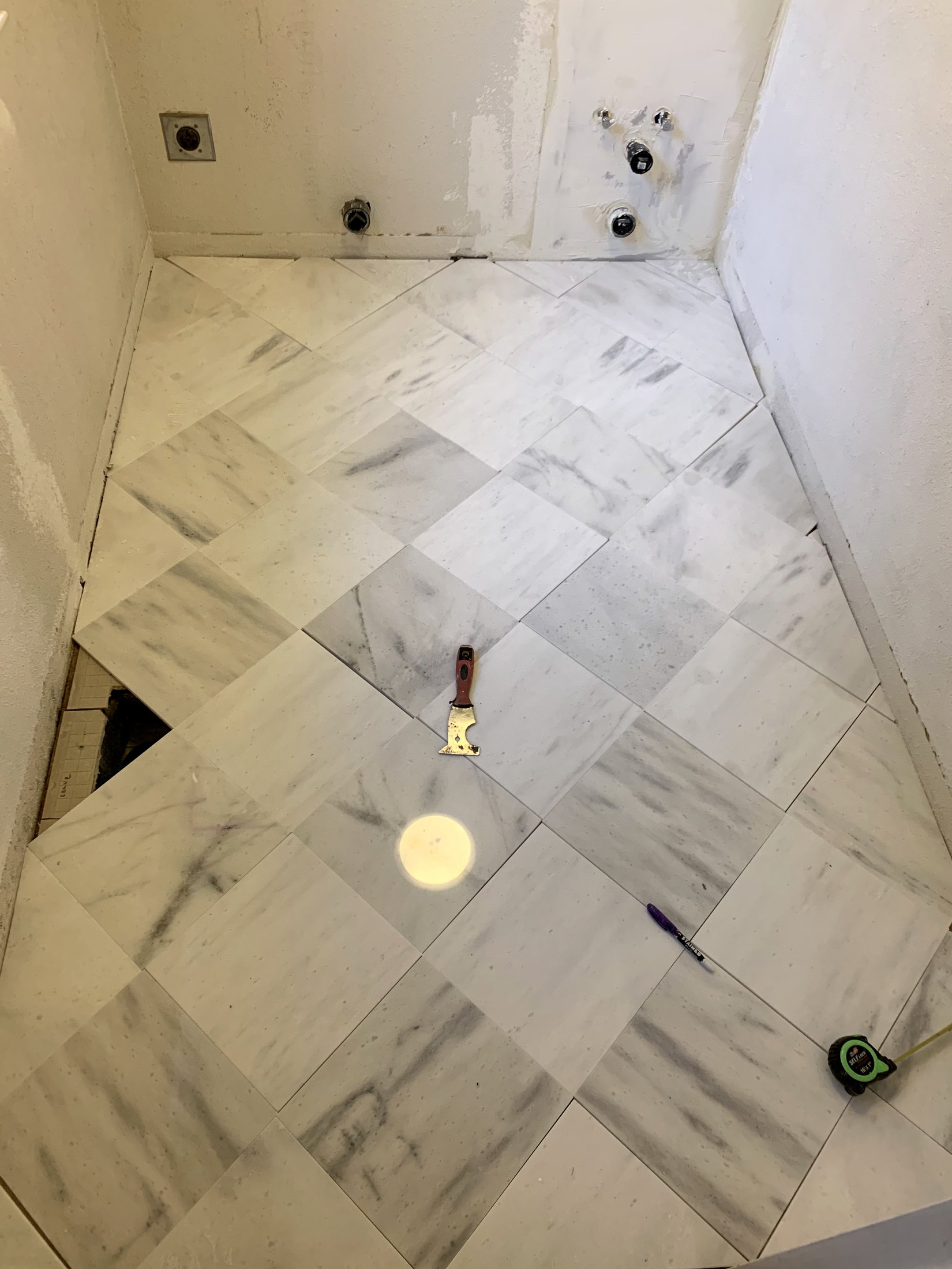 Marble floor being laid out in the California farmhouse laundry