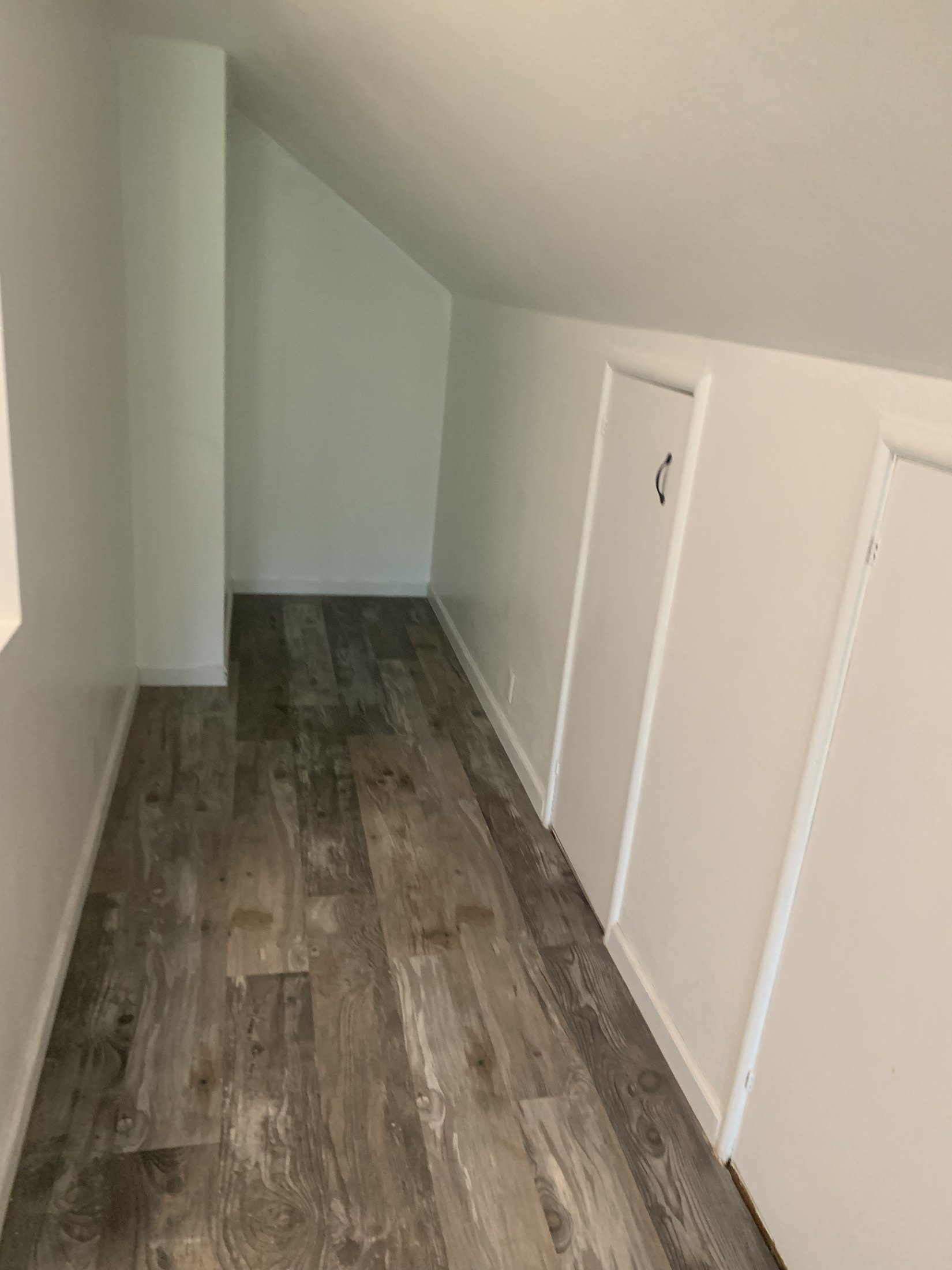 Low-eave circulation and fitted storage in the converted attic suite