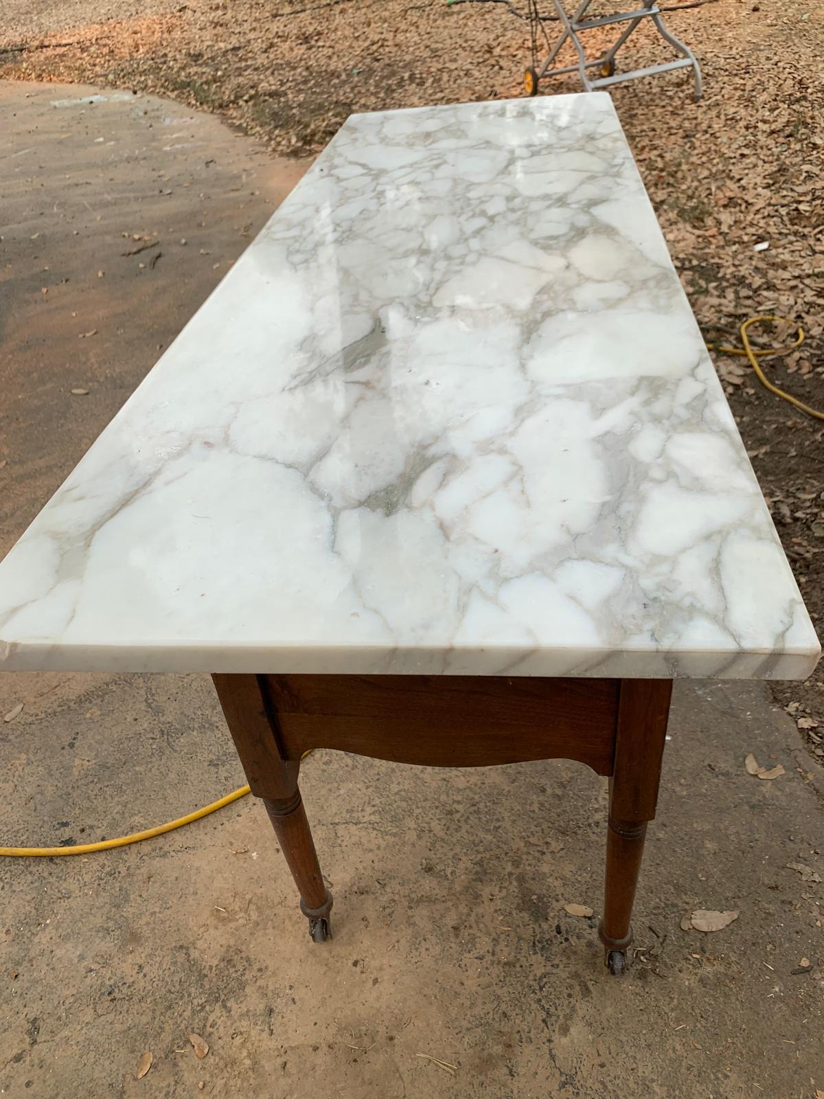 Close view of the salvaged marble slab resting on the antique washbasin during the work