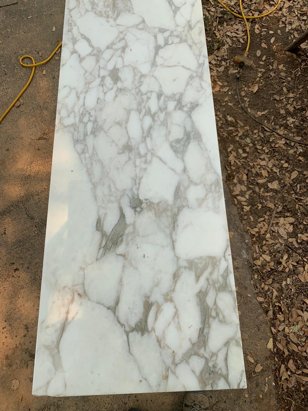 Full salvaged white marble slab with gray and warm taupe veining before it was cut