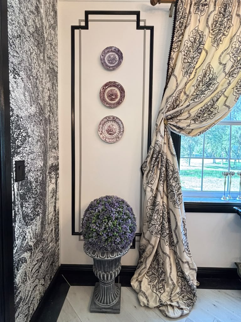 Formal dining room layered with mural, textiles, restored furniture, and collected objects