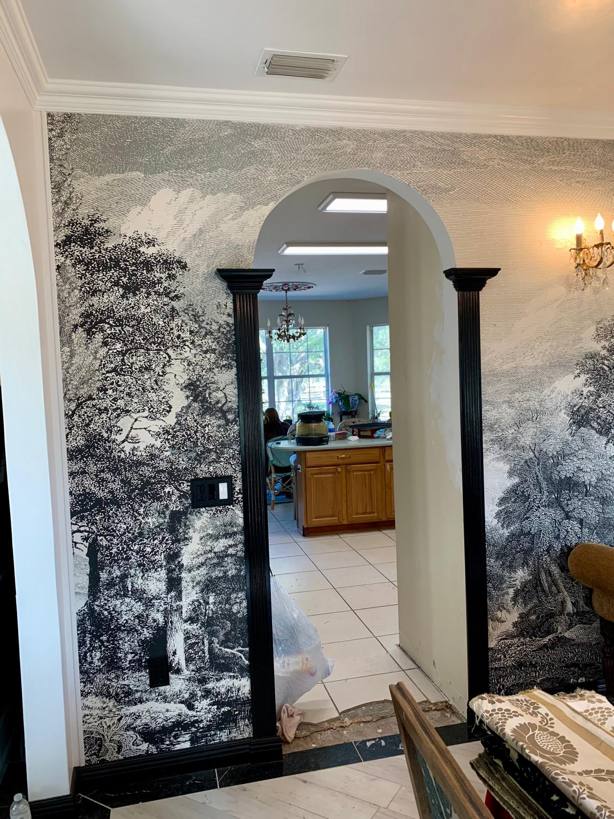 Arched opening with layered millwork and scenic mural